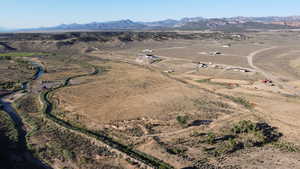 Aerial view of property's location featuring rural landscape and a mountainous background