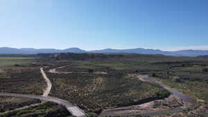 View of mountain backdrop with rural landscape