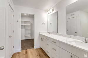 Bathroom with vanity, hardwood / wood-style flooring, and a textured ceiling