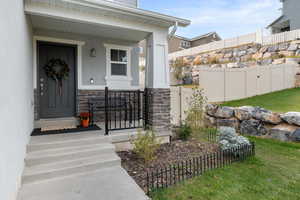 Doorway to property featuring covered porch