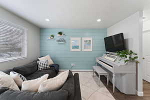 Living room featuring light LVP flooring and shiplap accent wall