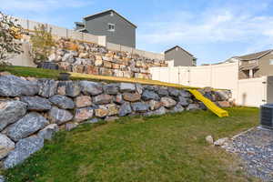 View of yard with a playground and cooling unit