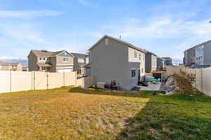 Back of property with a patio and a lawn