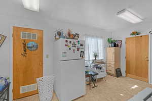 Interior space featuring white refrigerator