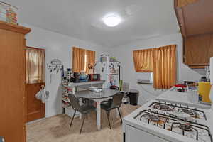 Kitchen with white appliances and tasteful backsplash