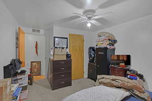 Carpeted bedroom with ceiling fan