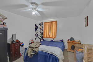 Bedroom with ceiling fan and light colored carpet