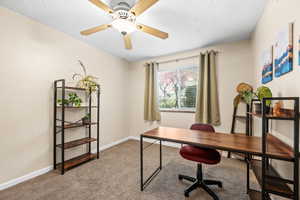 Carpeted home office with ceiling fan