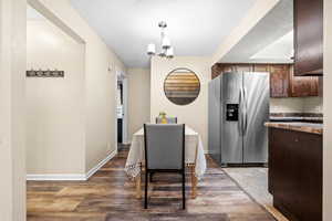 Dining room featuring hardwood / wood-style flooring and an inviting chandelier