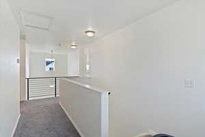 Hallway featuring carpet flooring