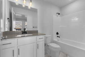 Full bathroom with vanity, shower / bathing tub combination, and toilet