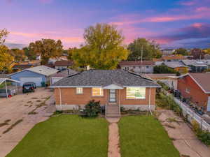 Single story home with a lawn and a garage