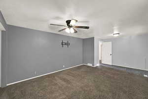 Carpeted spare room featuring ceiling fan and a textured ceiling