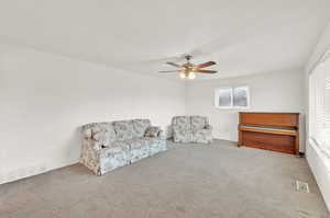 Sitting room featuring carpet floors and ceiling fan