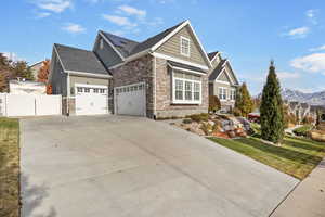 View of front of property with a mountain view and a front lawn