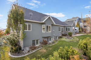 Back of property with a yard and a patio area