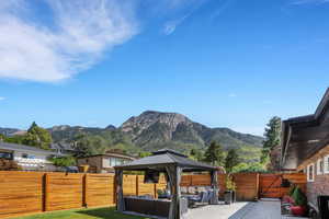 Exterior space with a gazebo, an outdoor living space, and a mountain view