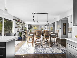 Dining area with dark hardwood / wood-style flooring