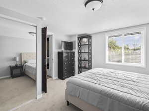 Carpeted bedroom featuring a textured ceiling