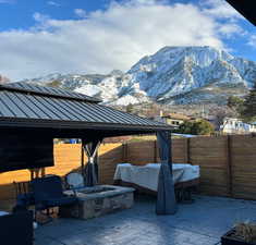 View of patio with a mountain view and a fire pit