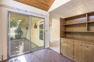 Sitting room/studio also features built-in shelves and cabinets and sliding doors onto thecourtyard patio