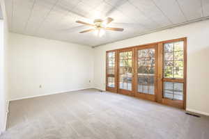 Master bedroom with French doors opening onto backyard deck with hot tub