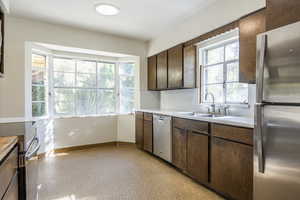 Kitchen featuring sink, stainless steel appliances, and wooden cabinets