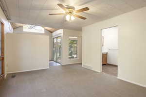 View into sitting room/studio with vaulted ceiling and clerestory window (left) and intobathroom and walk-in closet (right) from master bedroom