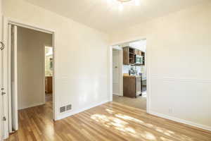 View from dining room into kitchen and back hallway