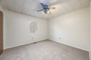 Bedroom 2 with west-facing window, ceiling fan, large closet with built-in drawers, and alarge skylight