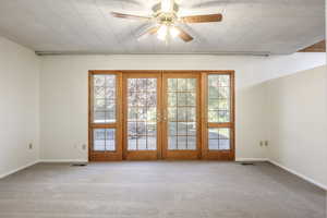 North wall of master bedroom French doors opening onto backyard deck with hot tub