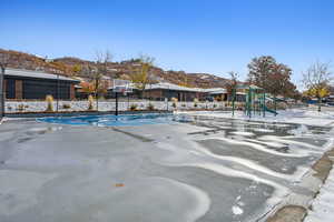 View of swimming pool featuring a mountain view and a playground