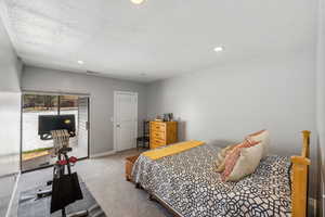 Carpeted bedroom featuring a textured ceiling