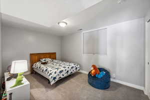 Carpeted bedroom with a textured ceiling