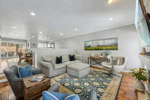 Living room featuring light hardwood / wood-style flooring and ornamental molding