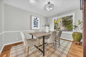 Dining area with hardwood / wood-style flooring