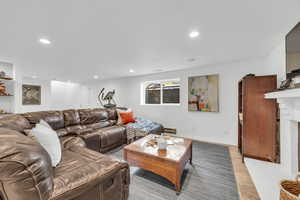 Living room featuring a fireplace and baseboard heating