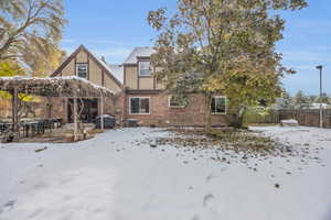 Snow covered back of property with cooling unit