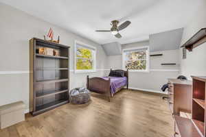 Bedroom featuring light hardwood / wood-style flooring, ceiling fan, and lofted ceiling