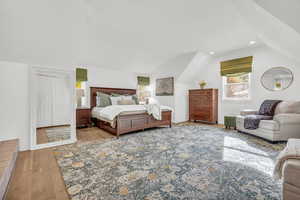 Bedroom featuring light hardwood / wood-style floors and lofted ceiling