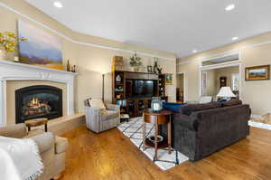 Living room featuring light hardwood, gas F/P and crown molding