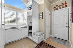 Mudroom featuring light tile patterned floors