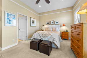 Carpeted bedroom featuring ceiling fan