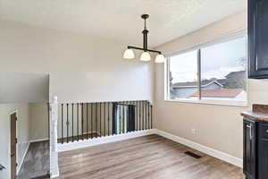 Dining room featuring hardwood / wood-style floors and a textured ceiling