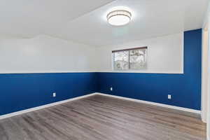 Empty room with wood-type flooring and a textured ceiling