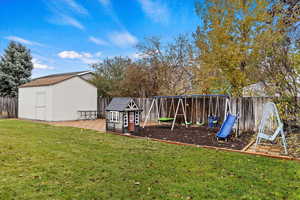 View of yard with a storage unit, a playground, and a patio