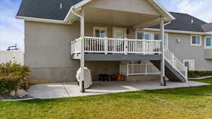 Back of property featuring a lawn and a patio area