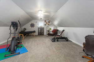 Workout area with carpet floors, vaulted ceiling, and ceiling fan