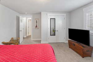 Carpeted bedroom featuring a closet