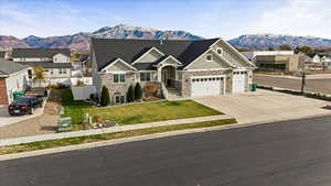 Craftsman-style home featuring a mountain view, a garage, and a front yard